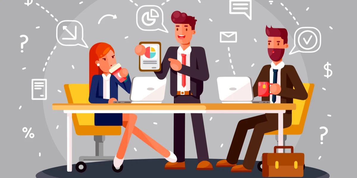 3 animated characters at desk with computers and the middle guy standing holding clipboard with graph